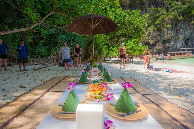 ECO Premium Island Hopping to Hong Island Tour by Longtail Boat - Pak Bia lunch setup: snacks, fruit punch, and a beach buffet that fits the day