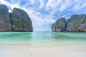 From Phi Phi: Sunrise Maya Bay, Pileh Lagoon Speedboat Tour - Maya Bay beach time: cliffs, walking, and that early-light payoff